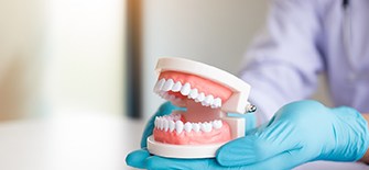 dental professional holding dentures