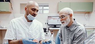 Patient in Indianapolis talking to dentist about dentures