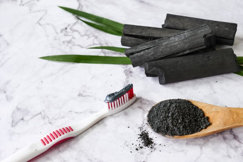 A toothbrush using charcoal toothpaste for teeth whitening